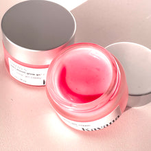 Load image into Gallery viewer, Rose Moon Glow Gel Cream is a lightweight primer and moisturizer, 2-in-1. Pictured here, the open jar with a brushed, matte silver coloured cap, perched on the lip of the jar. Another jar flipped on it's side, cane be seen, the pink colour of the gel showing through it. This gel goes on clear on the skin, leaving now colour behind.