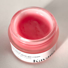 Load image into Gallery viewer, Rose Moon Glow Gel Cream is a lightweight primer and moisturizer, 2-in-1. Pictured here, the open jar with a brushed, matte silver coloured cap, perched on the lip of the jar. Another jar flipped on it's side, cane be seen, the pink colour of the gel showing through it. This gel goes on clear on the skin, leaving now colour behind.