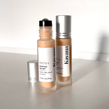Load image into Gallery viewer, Kavana's Phyto-5 Luminous Eye Gel, is seen here opened, with roller ball top showing and cap just off the bottle to the right , on a bed of stones at the beach. Packed with Green Coffee extract to depuff, Hyaluronic Acid to hdyrate, Blue Cornflower to soothe and a mica blend to hilight, this is the cooling eye gel you need! It also has Kavana's signature Phyto-5 plant blend of Calendula, COmfrey, Echinacea, Plantain and Rosehip seed oil. Delighftul as a 2-in-1 multipurpose skincare and makeup product!