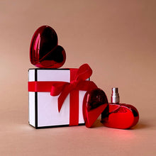 Load image into Gallery viewer, Clean, safe, non-toxic fragrance at it's best! Packaged in a refillable, recyclable cherry red and reflective, aluminum heart-shaped glass bottle, this gourmand fragrance is an ode to love. The combination of aphrodisiac essential oils and warm, full bodied resins of tonka bean , benzoin and ylang ylang, topped with a refreshing citrus note of lemon, LEV makes for an original scent that is one-of a kind. Lev is seductive, sophisticated, simple and sweet all at once.