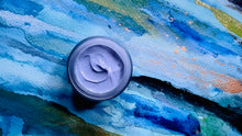 Load image into Gallery viewer, Open jar of Kavana's Phyto-5 Blue Moon Rich Night Cream. The cream is blue and on a painted blue aquarelle background with specks of gold, black, orange and green on a watercolour blue that looks like water.