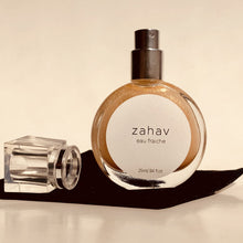 Load image into Gallery viewer, Kavana's Zahav, Eau fraiche, is a handmade, non-toxic light fragrance with a hint of golden shimmer.  Perfect for a summer hair spritz to add shine and delicious scent to the hair.  It's an updated nod to classic Eau de Cologne- a fresh and sophisticated citrus bouquet, blended with white flowers of neroli and orange blossom. An intoxicating and heady blend.