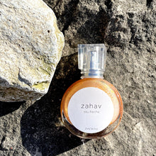 Load image into Gallery viewer, Kavana's Zahav, Eau fraiche, is a handmade, non-toxic light fragrance with a hint of golden shimmer. Perfect for a summer hair spritz to add shine and delicious scent to the hair. It's an updated nod to classic Eau de Cologne- a fresh and sophisticated citrus bouquet, blended with white flowers of neroli and orange blossom. An intoxicating and heady blend.
