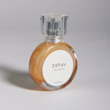 Load image into Gallery viewer, Kavana's Zahav, Eau fraiche, is a handmade, non-toxic light fragrance with a hint of golden shimmer. Perfect for a summer hair spritz to add shine and delicious scent to the hair. It's an updated nod to classic Eau de Cologne- a fresh and sophisticated citrus bouquet, blended with white flowers of neroli and orange blossom. An intoxicating and heady blend.