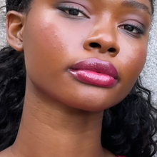 Load image into Gallery viewer, Model Raissa is seen in close up wearing Kavana Phyto-5 Tinted Lip Treatment oil in Grenadine- a rich pomegranate berry colour. 
