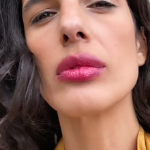 Load image into Gallery viewer, Model Kristel is seen in a tight close up, wearing Grenadine- a sheer pomegranate shade of Kavana&#39;s Phyto-5 Tinted LIp Treatment oil series.
