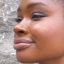 Load image into Gallery viewer, Model Raissa seen in profile, wears Kavana&#39;s Phyto-5 TInted Lip oil in Praline- a sheer browny rose.

