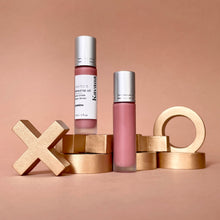 Load image into Gallery viewer, Kavana&#39;s PHyto-5 Tinted lip treatment oil in shade Gamine, is a soft, sheer browny rose. Seen here, the bottle is open, the cap is off and the note it is on top of with a lip print, says &#39;je t&#39;embrasses, xoxo&#39;. French for &quot;i kiss you&#39;. 
