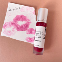 Load image into Gallery viewer, Kavana&#39;s Phyto-5 Tinted Lip Treatment oil in Sanguine, a sheer, raspberry red with blue undertones. Seen here over a love note that says &#39;be mine&#39;. The perfect juicy Macintosh red for every day or Valentines day!
