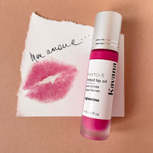 Load image into Gallery viewer, Kavana&#39;s Phyto-5 Tinted Lip Treatment oil in Eglantine, a bright fucshia, with blue undertones. The bottle sits atop a love note that says &#39;mon amour&#39; with a bright fuschia kiss mark on it!
