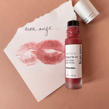 Load image into Gallery viewer, Kavana&#39;s Phyto-5 Tinted Lip Treatment oil in shade Seraphine, a warm, golden terracotta brown, a dramatic and bold choice but still neutral. Gorgeous on the cheeks too! Seraphine is seen here, atop a love note that says &#39;mon ange&#39;, my angel.

