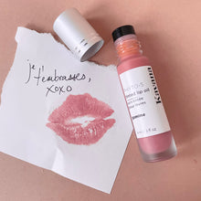 Load image into Gallery viewer, Kavana&#39;s PHyto-5 Tinted lip treatment oil in shade Gamine, is a soft, sheer browny rose. Seen here, the bottle is open, the cap is off and the note it is on top of with a lip print, says &#39;je t&#39;embrasses, xoxo&#39;. French for &quot;i kiss you&#39;. 
