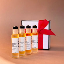 Load image into Gallery viewer, Kavana&#39;s four Perfume Poems in the Quattro set, from left to right: Grapefrit, Peppermint, Plai and Rose Perfume Poem. in front of a white box with black outline and a red grosgrain ribbon - aviailable gift wrap for holiday only.

