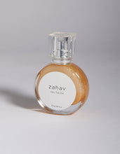 Load image into Gallery viewer, Kavana&#39;s Zahav, Eau fraiche, is a handmade, non-toxic light fragrance with a hint of golden shimmer.  Perfect for a summer hair spritz to add shine and delicious scent to the hair.  It&#39;s an updated nod to classic Eau de Cologne- a fresh and sophisticated citrus bouquet, blended with white flowers of neroli and orange blossom. An intoxicating and heady blend.
