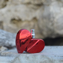 Load image into Gallery viewer, Clean, safe, non-toxic fragrance at it&#39;s best! Packaged in a  refillable, recyclable cherry red and reflective, aluminum heart-shaped glass bottle, this gourmand fragrance is an ode to love. The combination of aphrodisiac essential oils and warm, full bodied resins of tonka bean , benzoin and ylang ylang, topped with a refreshing citrus note of lemon, LEV makes for an original scent that is one-of a kind. Lev is seductive, sophisticated, simple and sweet all at once.
