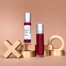 Load image into Gallery viewer, Kavana&#39;s Phyto-5 Tinted Lip Treatment oil in Sanguine, a sheer, raspberry red with blue undertones. Seen here over a love note that says &#39;be mine&#39;. The perfect juicy Macintosh red for every day or Valentines day!
