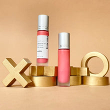 Load image into Gallery viewer, Kavana&#39;s Phyto-5 Tinted Lip Treatment Oil is a  sheer, pale pinky coral, tone. The bottle is open here and the lip print on the note is signed &#39;xoxo, devine qui&#39;, french for &#39;guess who;. 
